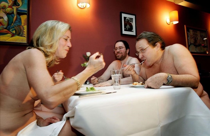 A group of nudists eat together at a Clothing Optional Dinner at a New York City restaurant February 17 2005 The diners arrived on a cold Thursday night looking remarkably respectable and stripped off scarves hats and coats They didn t stop there Sweaters shirts skirts pants underwear all end up stashed in a plastic bag by the bar This is the monthly Clothing Optional Dinner for a group of nudists who wanted something a bit more elegant than the wilderness getaways and beach resorts they generally frequent Around 30 people arrived for the buffet dinner -- no hot soup on the menu -- most of them middle-aged several married couples some singles the youngest perhaps in their 30s Health regulations mean staff must remain clothed even if they wanted to join in And diners must bring something to sit on -- a towel or for discerning women an elegant silk scarf FOR RELEASE WITH STORY LIFE-NAKED REUTERS Mike Segar